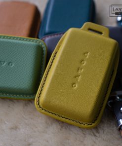 Close-up of several colorful leather key cases for Volvo EX30, EX40 and EX90 car keys. The cases are made of high-quality genuine leather and are available in a variety of colors with customizable stitching.